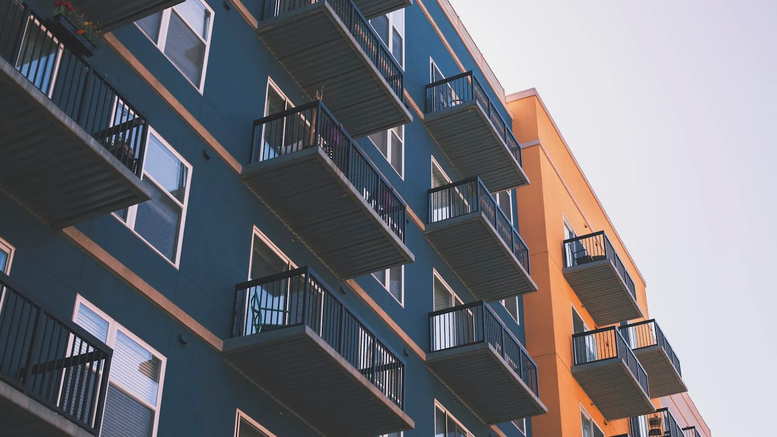 Fachada de prédios residenciais com sacadas em azul e laranja